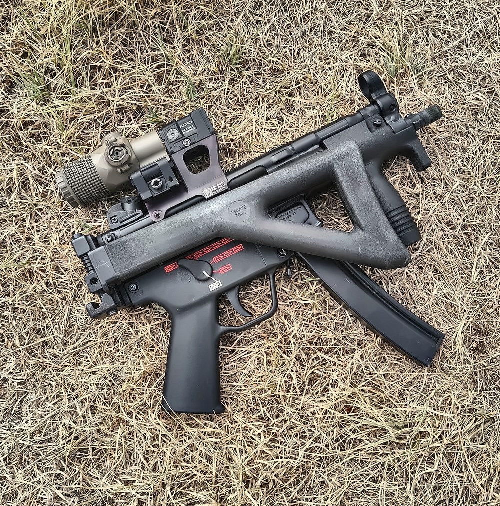 MP5K with the Hansel MP5 optics mount, an Aimpoint ACRO P-2, and a flip-to-side magnifier behind it