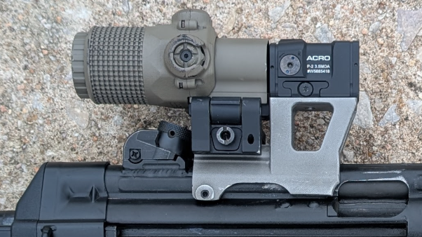 MP5 magnifier setup with a flip-to-side magnifier behind an Aimpoint ACRO P-2 on the Hansel MP5 optics mount